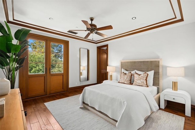 bedroom featuring crown molding, french doors, ceiling fan, and dark hardwood / wood-style flooring