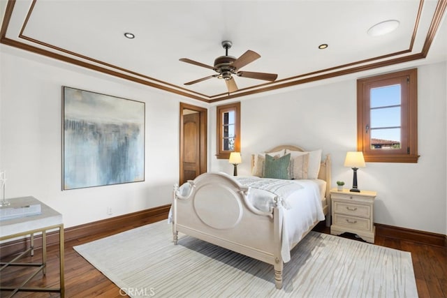 bedroom with ornamental molding, hardwood / wood-style floors, and ceiling fan