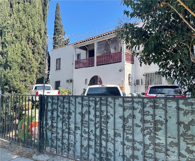 mediterranean / spanish-style home with a balcony