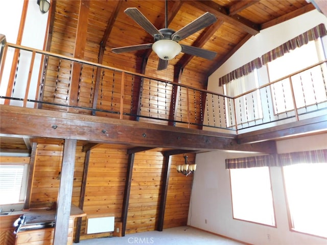 interior space featuring wooden ceiling, beamed ceiling, and ceiling fan