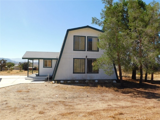 back of property featuring a mountain view