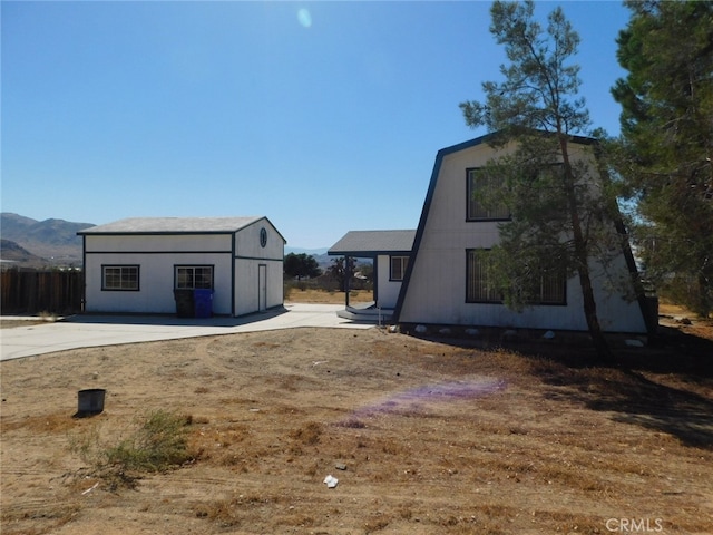 rear view of house featuring a mountain view