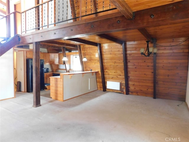 interior space featuring light colored carpet, wood walls, beam ceiling, and wooden ceiling