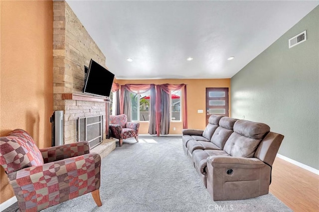 living room featuring a fireplace and light hardwood / wood-style flooring