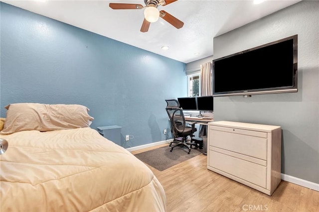 bedroom featuring light wood-type flooring and ceiling fan