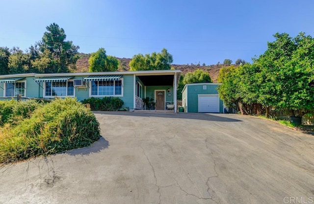 single story home with an outbuilding and a garage