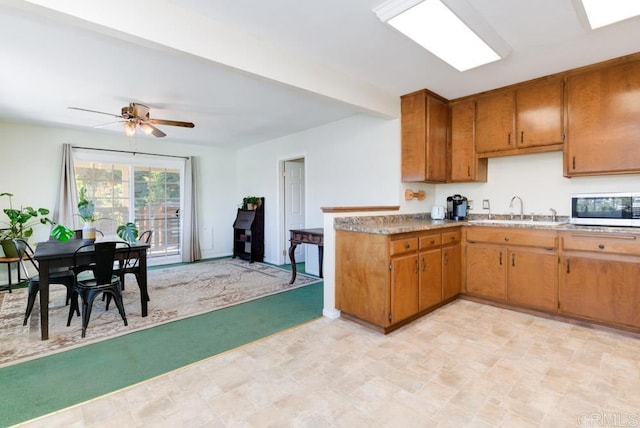 kitchen with ceiling fan and sink