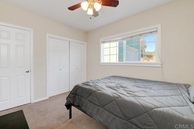 bedroom with light carpet and ceiling fan