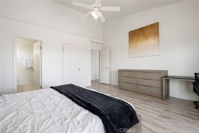 bedroom with light hardwood / wood-style floors, connected bathroom, and ceiling fan