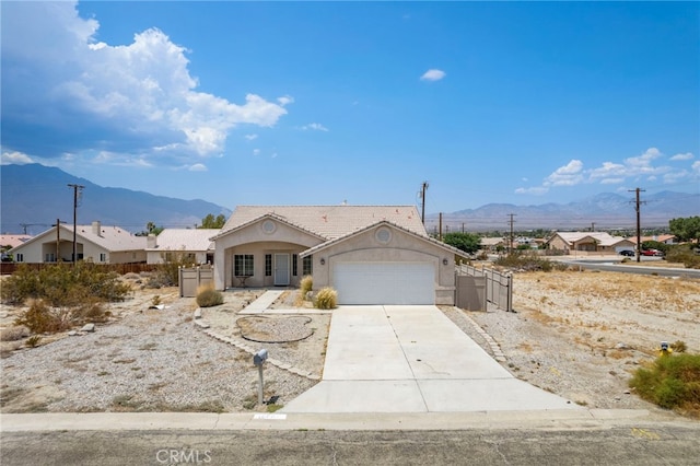 view of front facade with a garage and a mountain view