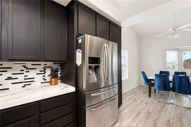 kitchen featuring light wood-type flooring, lofted ceiling, ceiling fan, tasteful backsplash, and stainless steel fridge with ice dispenser