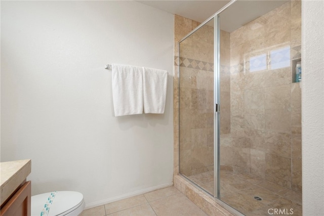 bathroom with a shower with door, tile patterned floors, vanity, and toilet