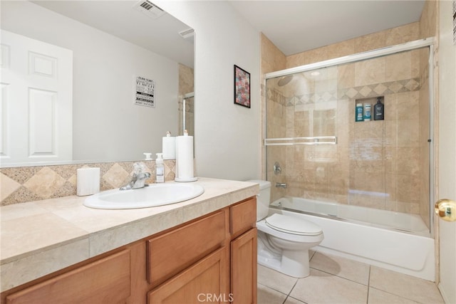 full bathroom with vanity, toilet, backsplash, combined bath / shower with glass door, and tile patterned flooring