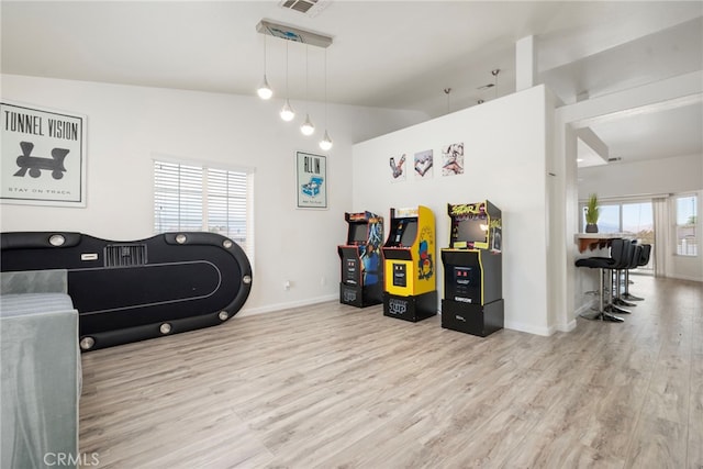 miscellaneous room with light wood-type flooring and vaulted ceiling