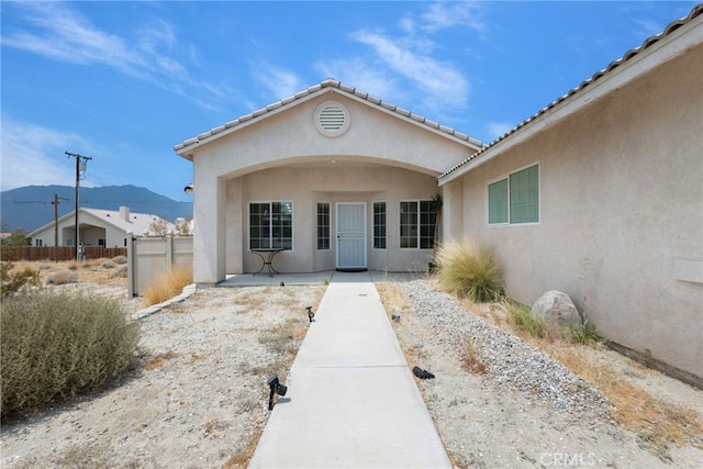 view of exterior entry with a mountain view