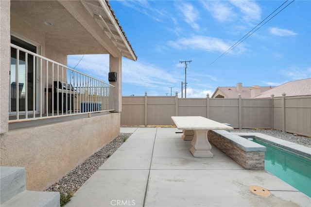 view of patio featuring a fenced in pool