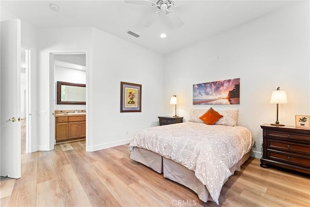 bedroom with ceiling fan, connected bathroom, and light wood-type flooring