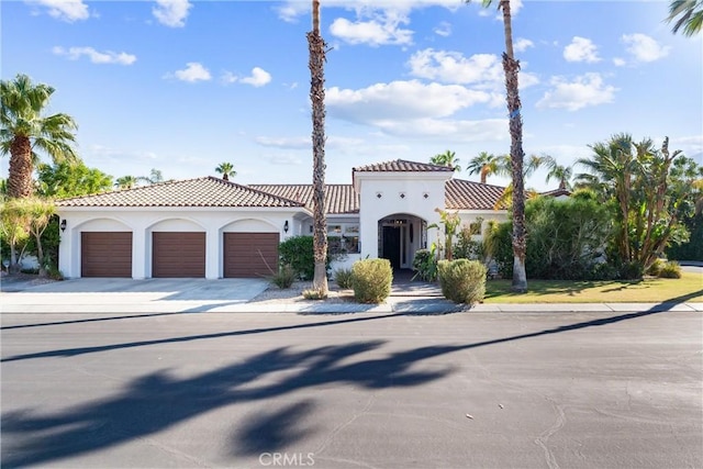 mediterranean / spanish home with a garage