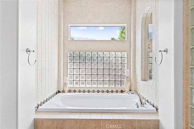 bathroom with tiled tub