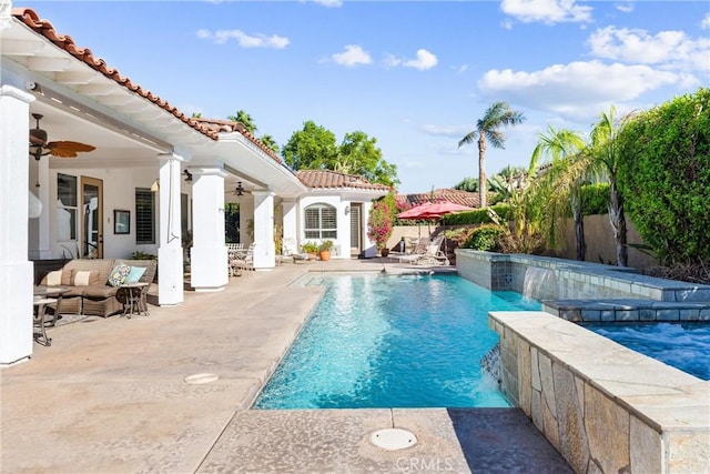 view of swimming pool featuring pool water feature, a jacuzzi, outdoor lounge area, ceiling fan, and a patio