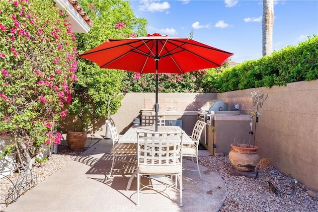 view of patio featuring a grill