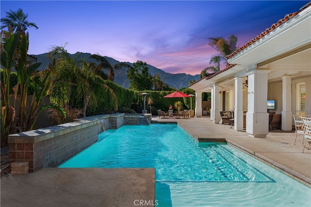 view of swimming pool with a patio area and pool water feature