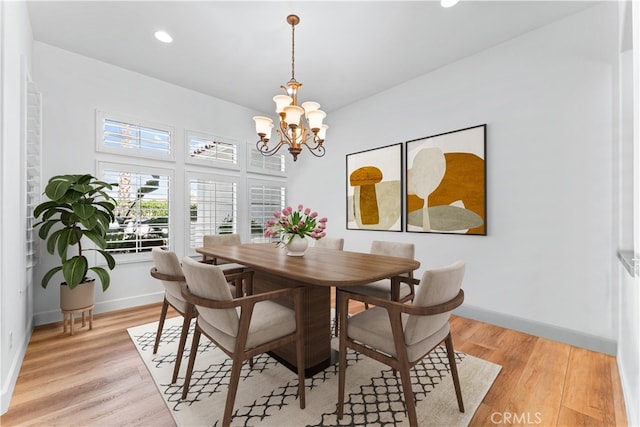 dining space with an inviting chandelier and light wood-type flooring