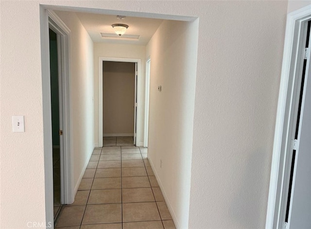 hall with light tile patterned floors