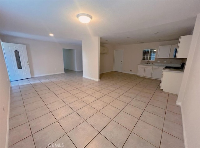 unfurnished living room featuring light tile patterned floors