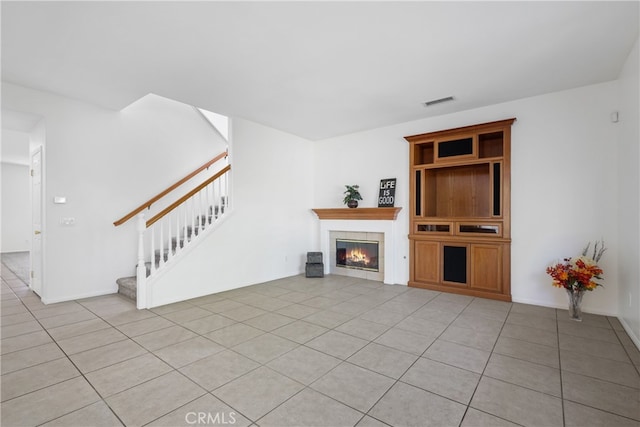 unfurnished living room featuring light tile patterned floors and a fireplace