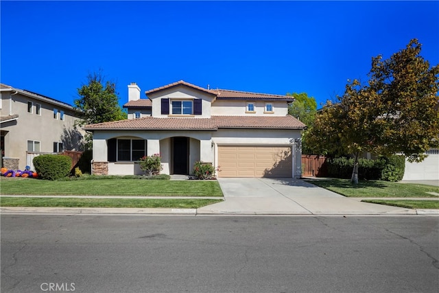 mediterranean / spanish-style home featuring a garage and a front lawn