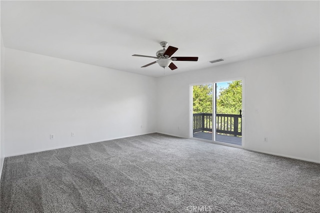 carpeted spare room with ceiling fan