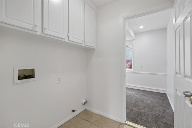 laundry area with washer hookup, light colored carpet, and cabinets