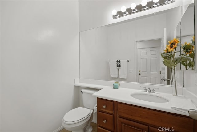 bathroom with toilet and vanity