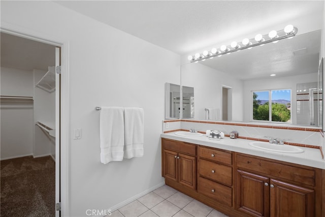 bathroom featuring vanity, tasteful backsplash, and tile patterned flooring