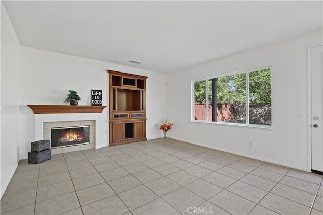 unfurnished living room featuring light tile patterned flooring and a fireplace