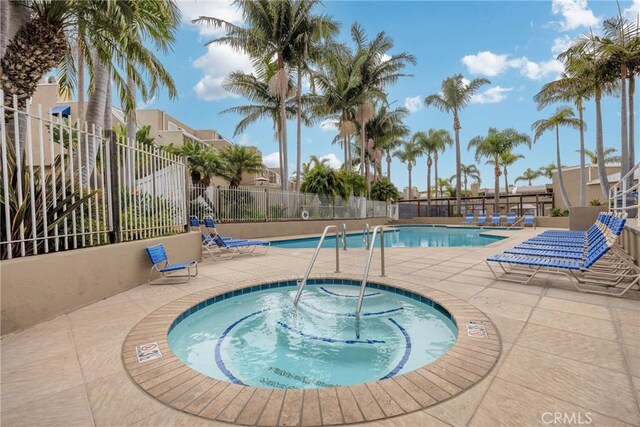 view of pool featuring a community hot tub and a patio