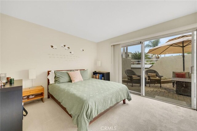 bedroom featuring access to outside and light colored carpet