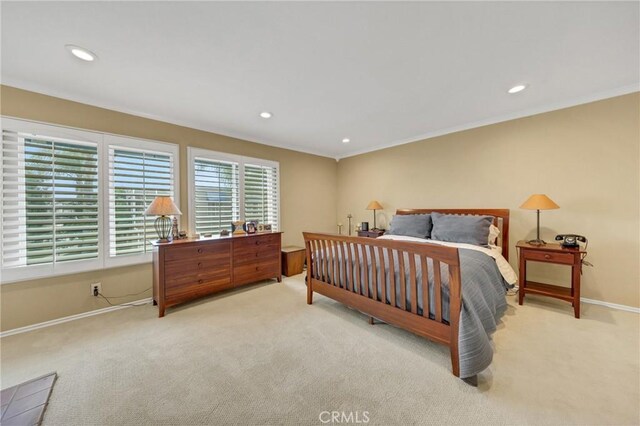 bedroom featuring light carpet and ornamental molding