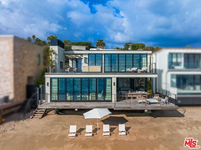 back of property with a balcony and a wooden deck