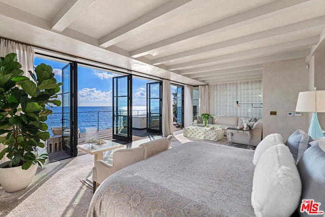 bedroom with access to exterior, beam ceiling, and a water view