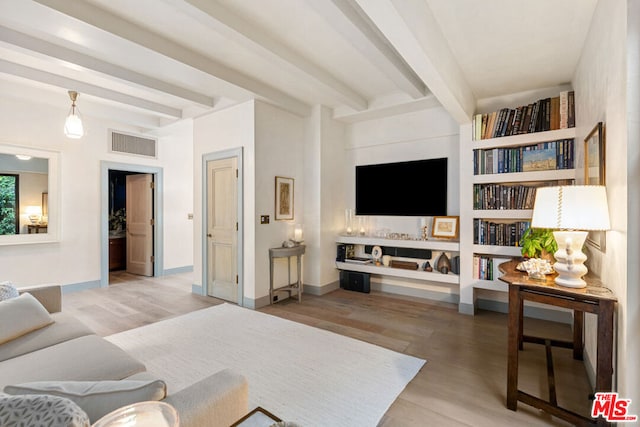 living room featuring wood-type flooring and beamed ceiling