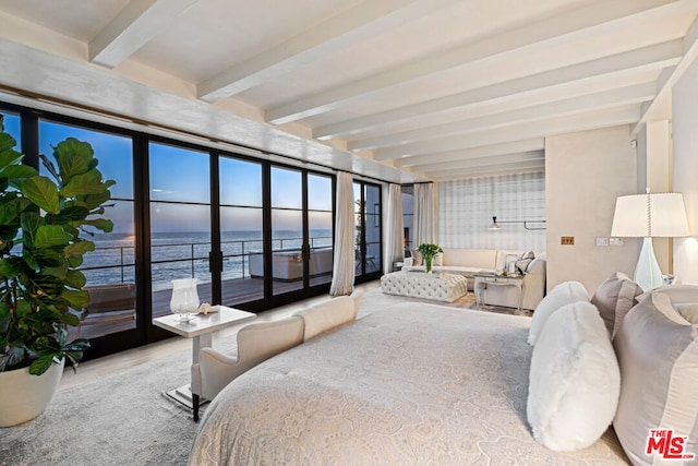 bedroom with hardwood / wood-style flooring, beam ceiling, and a water view