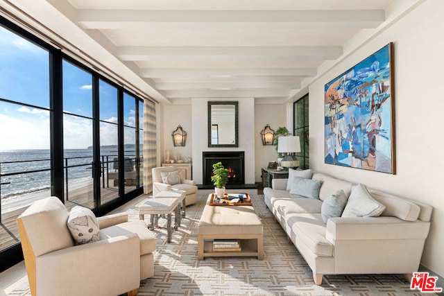 living room with a water view and beam ceiling