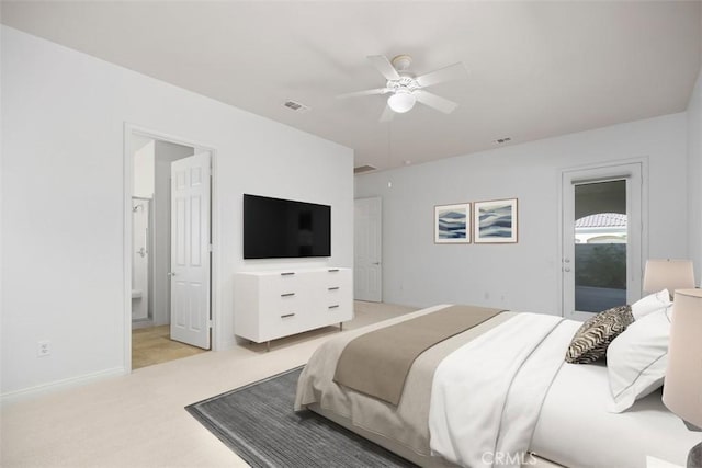 bedroom featuring connected bathroom, light colored carpet, and ceiling fan