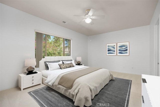 bedroom featuring light colored carpet and ceiling fan