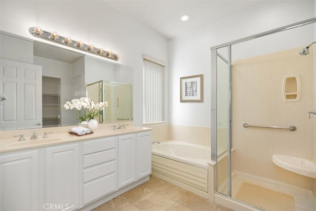 bathroom with tile patterned flooring, vanity, and shower with separate bathtub