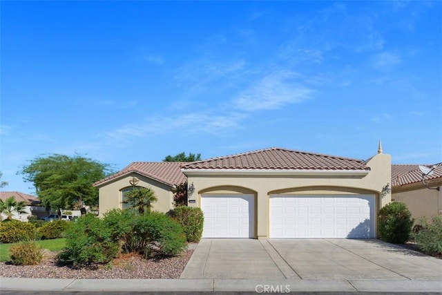 mediterranean / spanish-style home with a garage