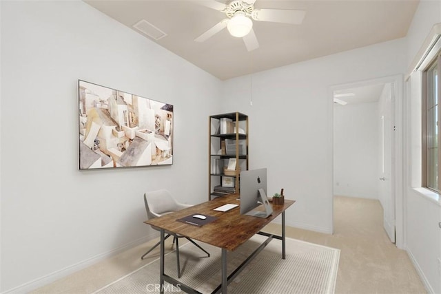 office space with ceiling fan and light carpet