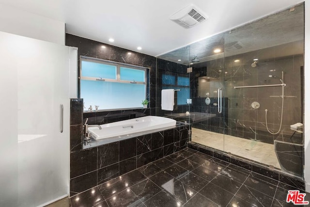 bathroom featuring separate shower and tub